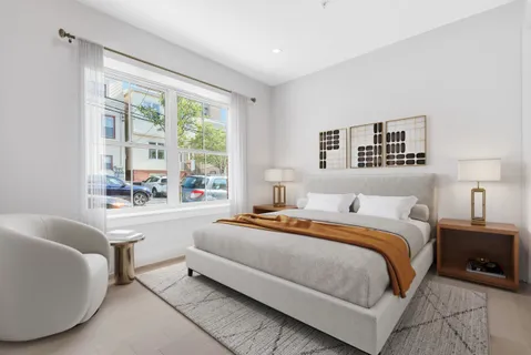 a bedroom with a large bed and a couch