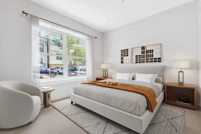 a bedroom with a large bed and a couch