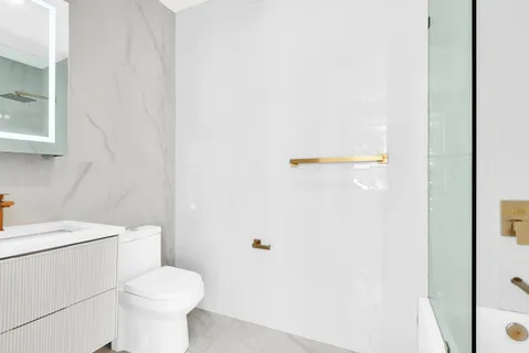 a white toilet sitting next to a white sink