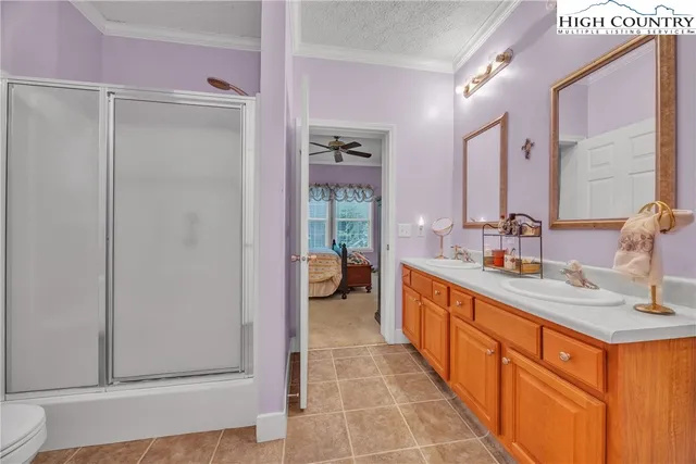 a large bathroom with a double vanity sink a mirror and a shower
