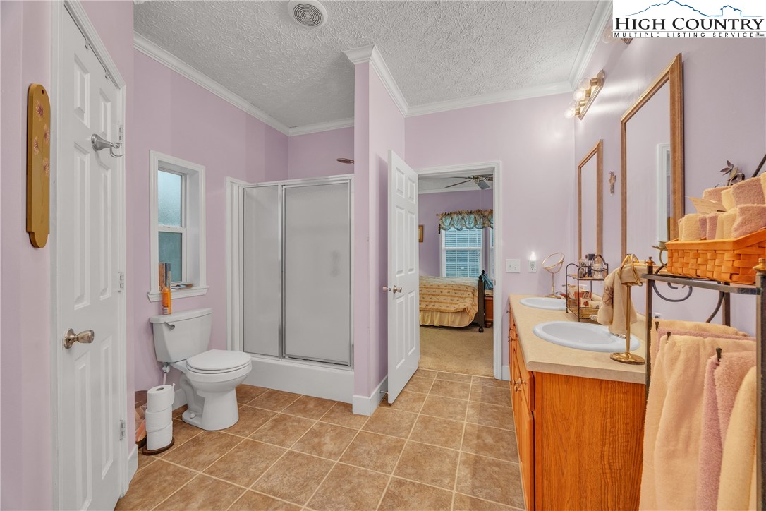 3786 Peak Road Creston, NC 28615 - Photo 12 of 44 a spacious bathroom with a sink mirror and toilet