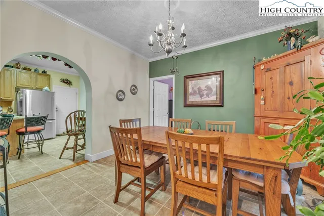 a view of a dining room with furniture and chandelier