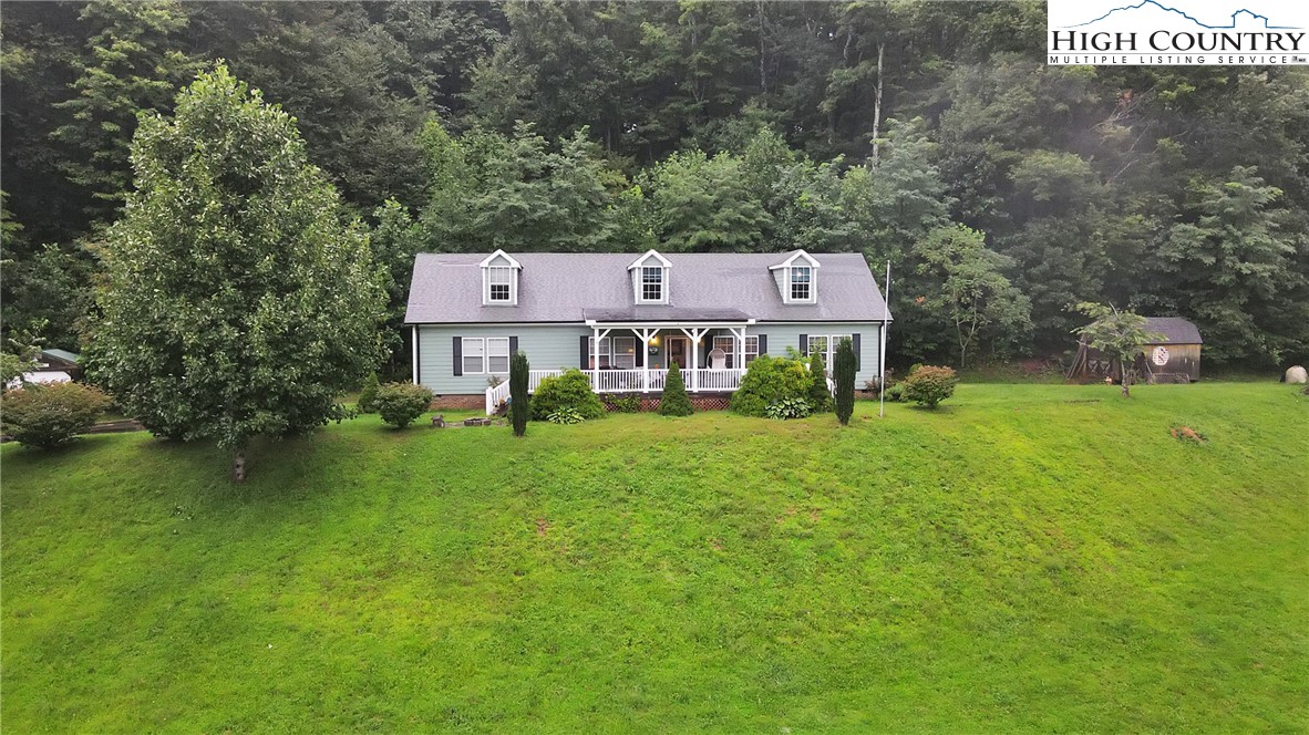 3786 Peak Road Creston, NC 28615 - Photo 19 of 31 a view of a big house with a big yard and large tree