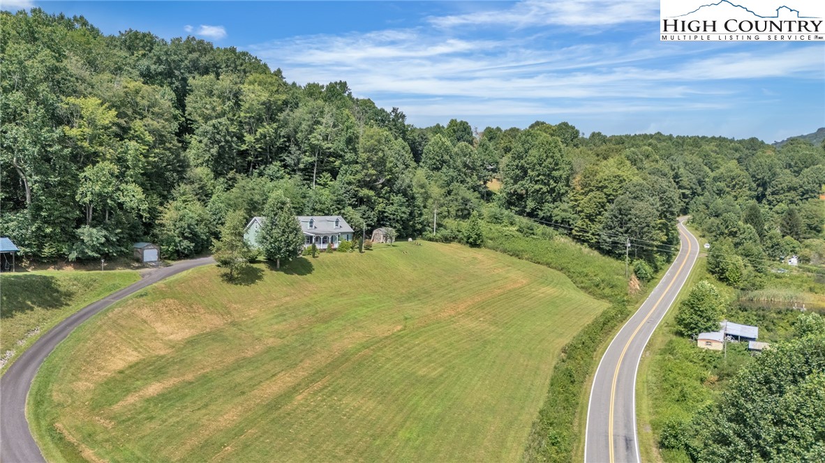 3786 Peak Road Creston, NC 28615 - Photo 2 of 31 a view of a swimming pool with a yard