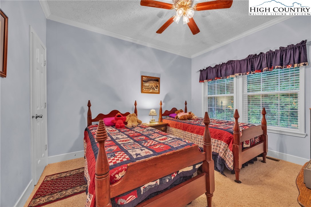 3786 Peak Road Creston, NC 28615 - Photo 21 of 44 a bedroom with a bed and window