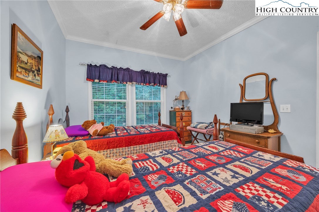 3786 Peak Road Creston, NC 28615 - Photo 22 of 44 a bedroom with a bed and wooden floor