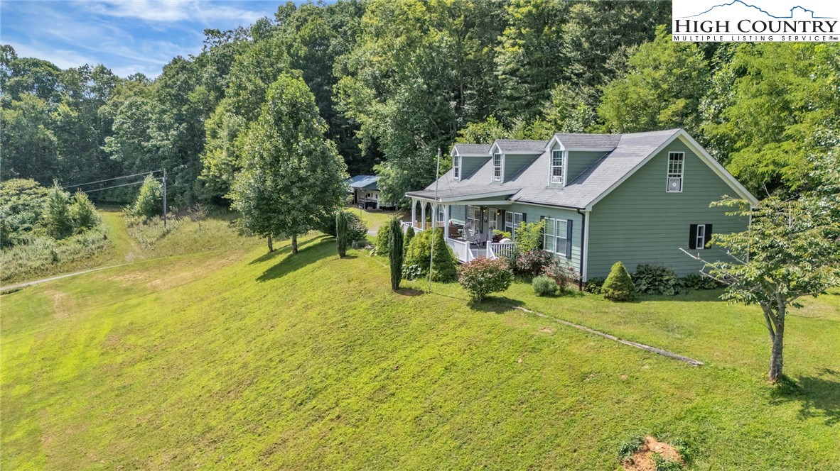 3786 Peak Road Creston, NC 28615 - Photo 23 of 31 a view of a house with a yard and sitting area