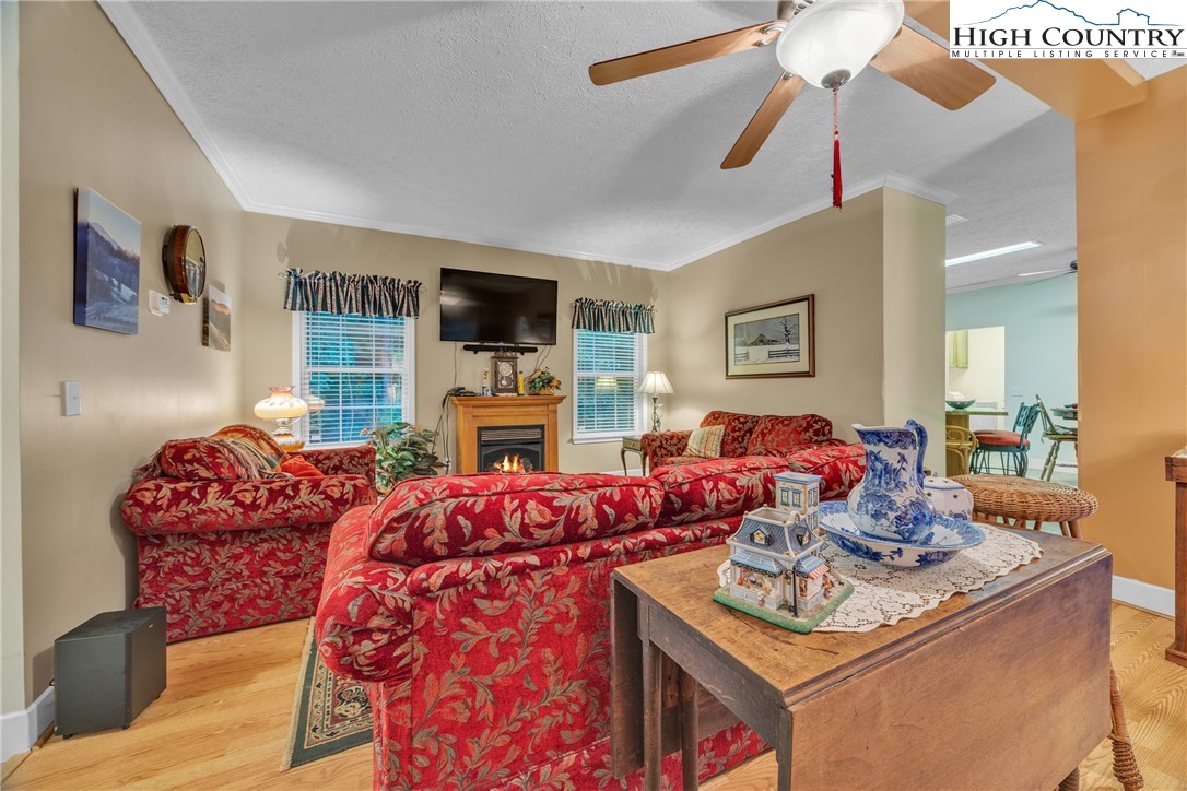 3786 Peak Road Creston, NC 28615 - Photo 25 of 44 a living room with furniture a fireplace and a flat screen tv