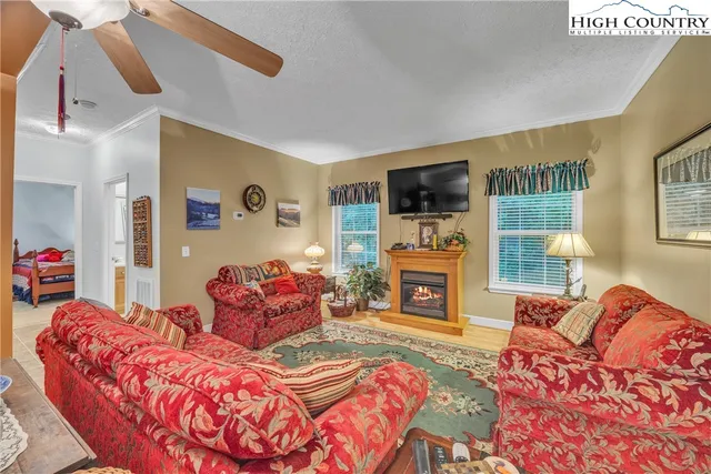 a living room with fireplace furniture and a flat screen tv