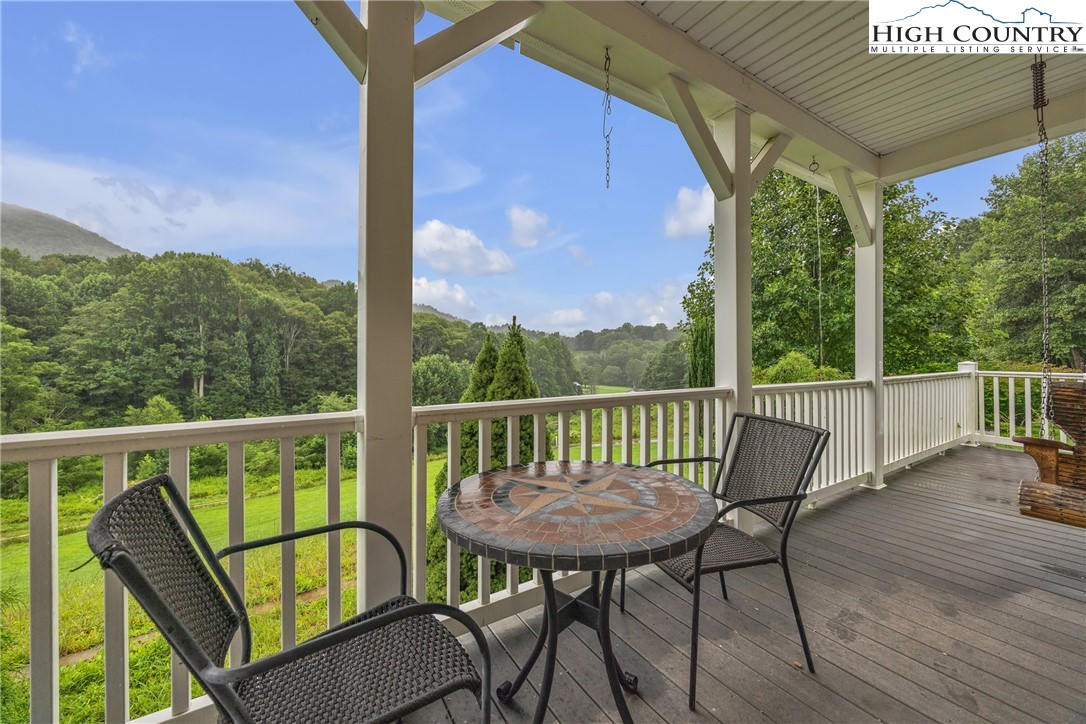 3786 Peak Road Creston, NC 28615 - Photo 3 of 44 a view of a balcony with chair and wooden floor