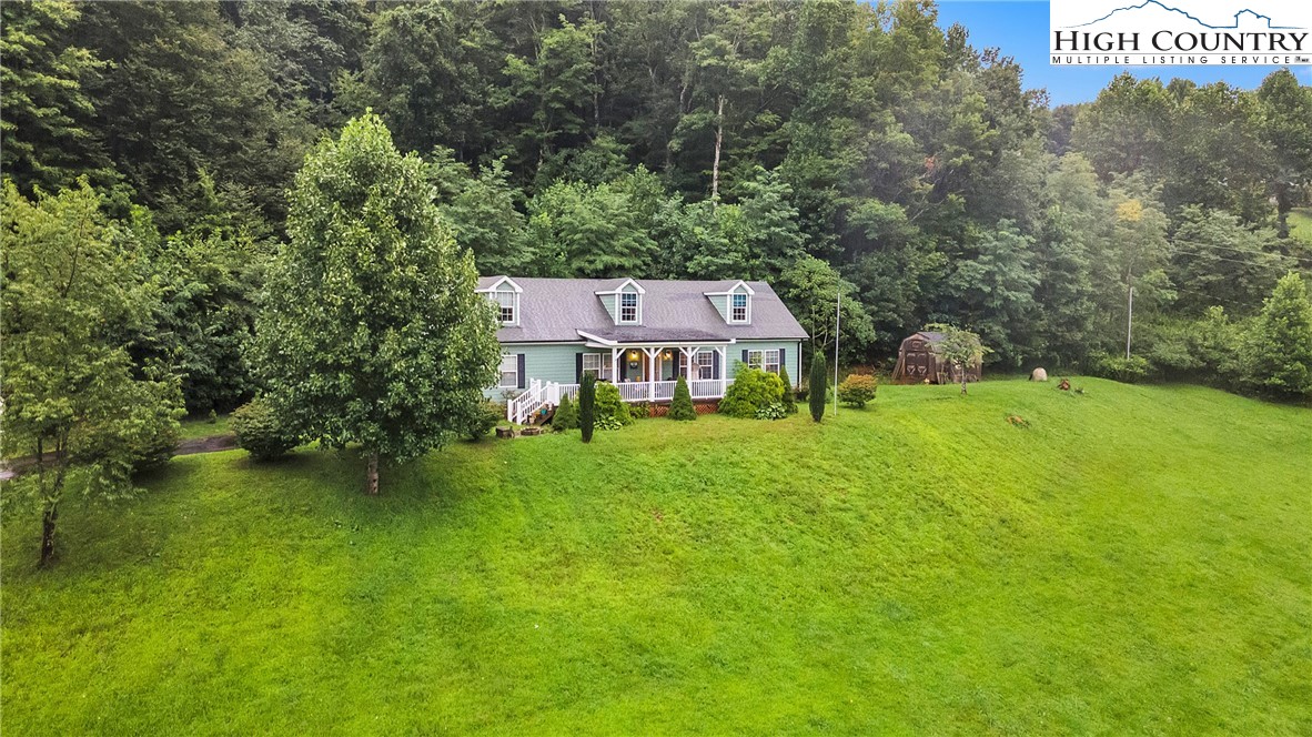 3786 Peak Road Creston, NC 28615 - Photo 39 of 44 an aerial view of a house with swimming pool and garden