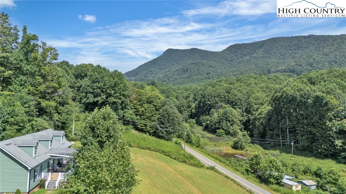 3786 Peak Road Creston, NC 28615 - Photo 41 of 44 a view of a lush green field with a house in the background
