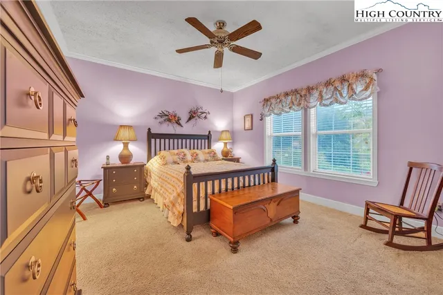 a bed room with a bed and a chair