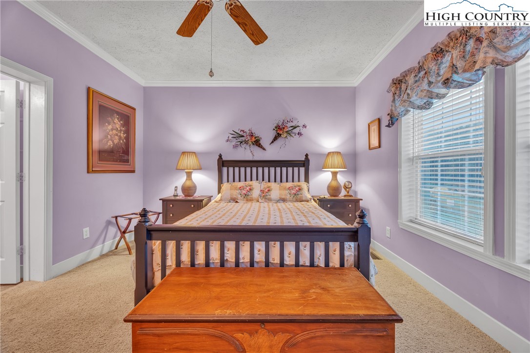 3786 Peak Road Creston, NC 28615 - Photo 8 of 44 a bedroom with a bed and a painting on the wall