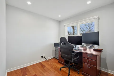 a view of a workspace with furniture and a window