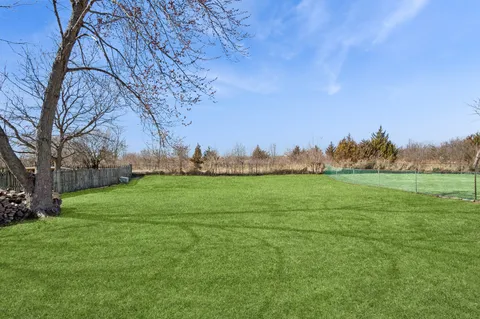 a view of field with grass and trees
