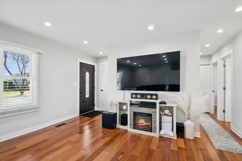 a living room with furniture flat screen tv and wooden floor