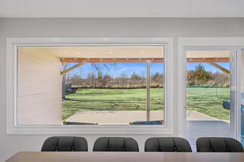 a living room with a large window and yard