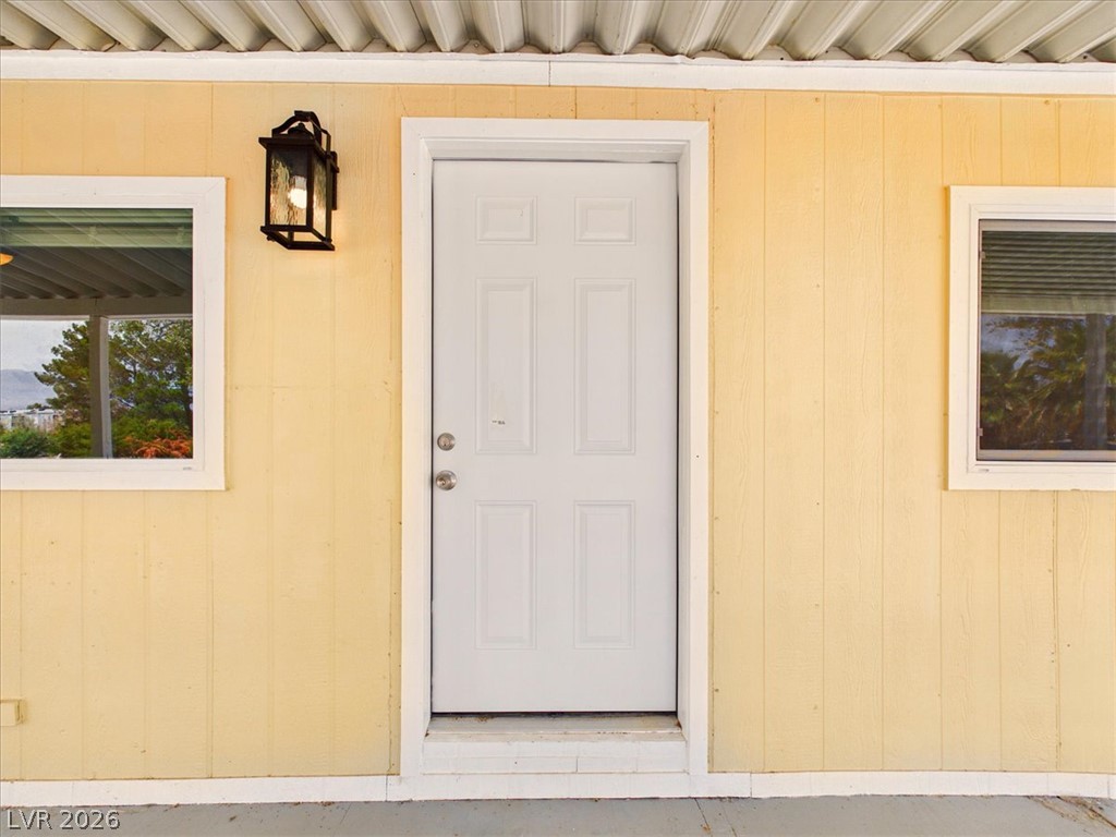4081 Retread Road Pahrump, NV 89048 - Photo 6 of 98 A welcoming front entry with bright siding and classic outdoor lighting awaits your personal touch.