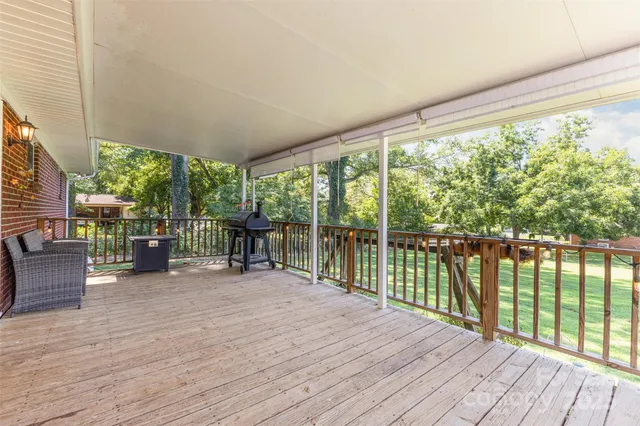 a view of a room with wooden floor and furniture