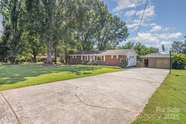 a view of house with outdoor space and swimming pool