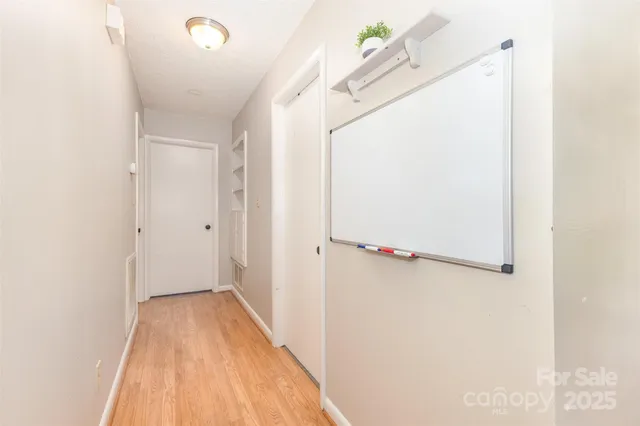 a view of a room with wooden floor and cabinet