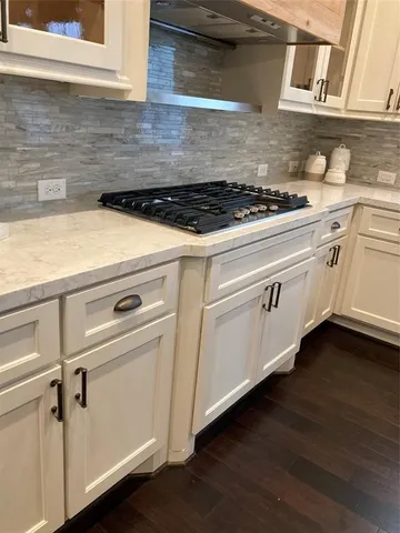 a white stove top oven sitting inside of a kitchen
