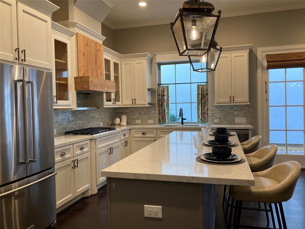 25110 Devlin Creek Drive Spring, TX 77380 - Photo 5 of 8 a kitchen with stainless steel appliances granite countertop a sink a stove and a refrigerator