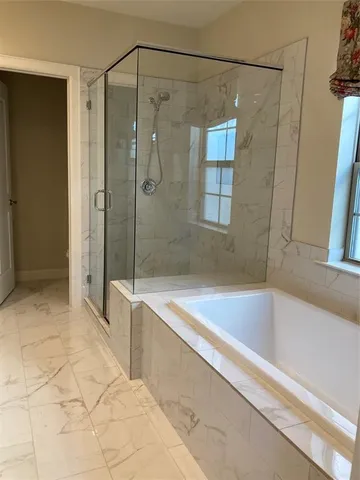 a spacious bathroom with a shower and a bathtub