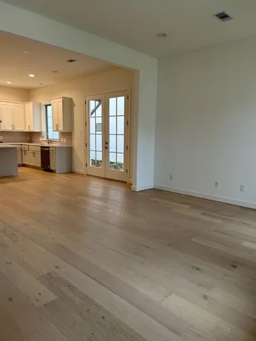 a view of an empty room with a kitchen stove back oven