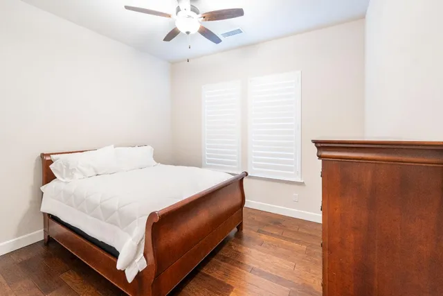 a bedroom with a white bed and a window