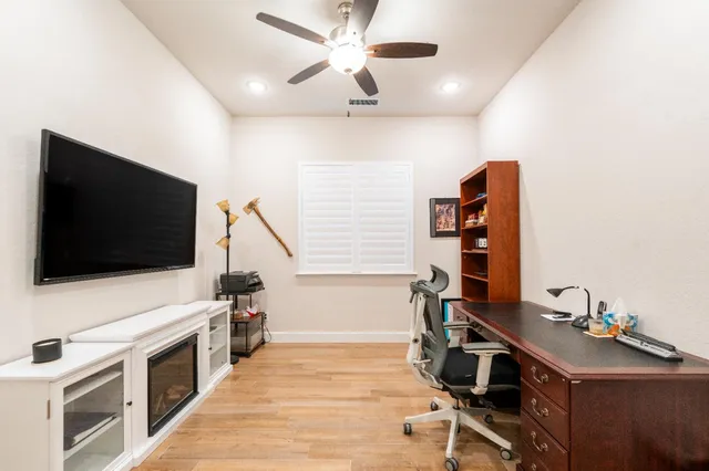 a living room with a flat screen tv and a fireplace