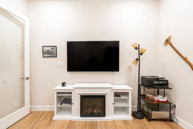 a kitchen with stainless steel appliances kitchen island a large island in the center a sink cabinets and wooden floor