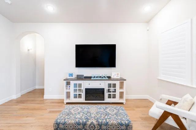 a large white kitchen with stainless steel appliances