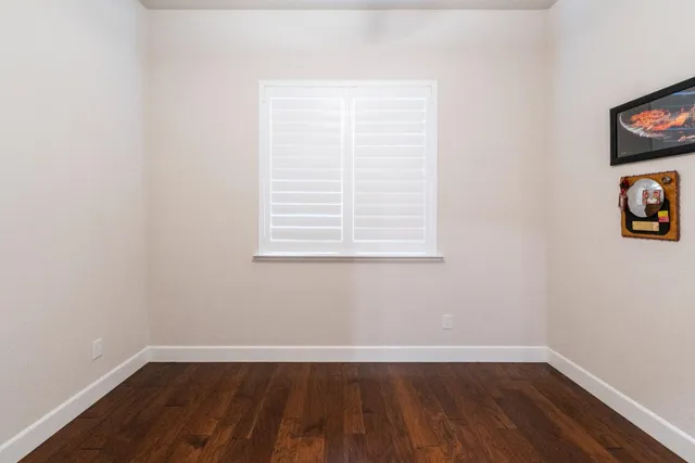 an empty room with wooden floor and closet