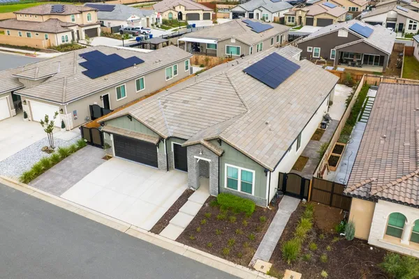 an aerial view of residential houses with outdoor space