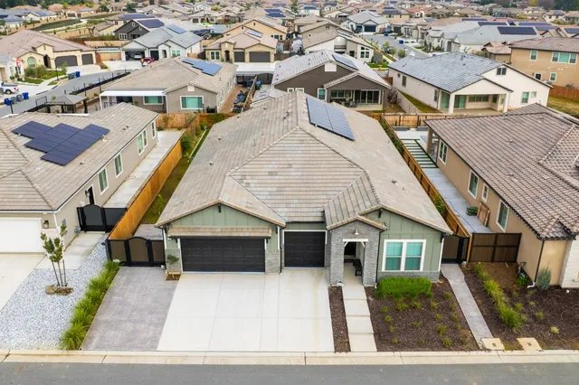 an aerial view of a house with a yard
