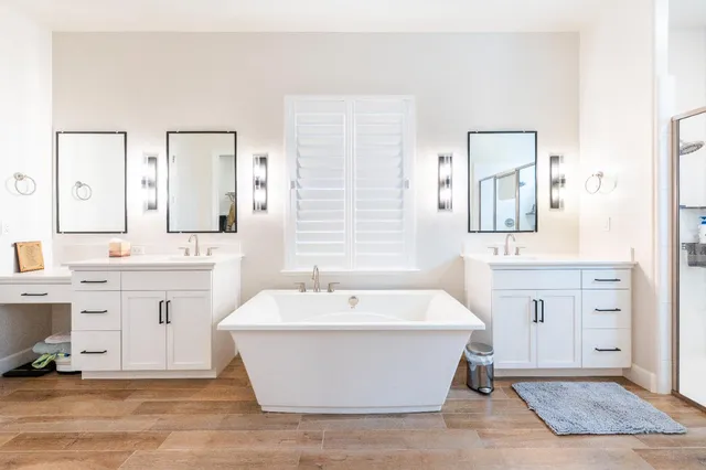 a bathroom with a sink a mirror and shower