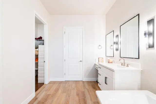a bathroom with a double vanity sink and a mirror