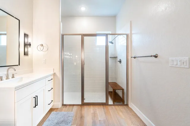 a bathroom with a glass shower door