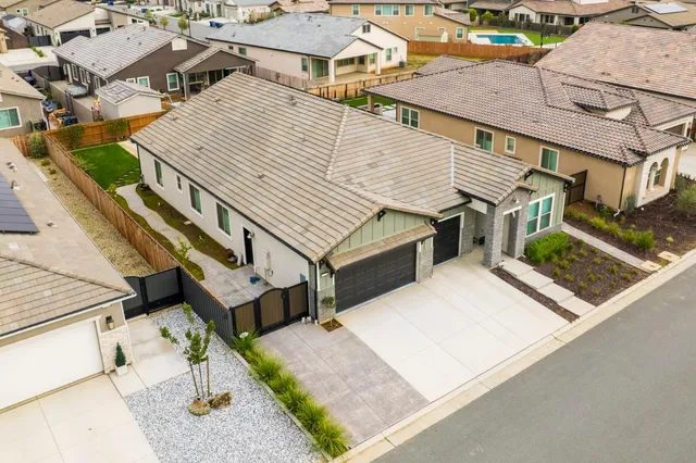 an aerial view of a house with a yard