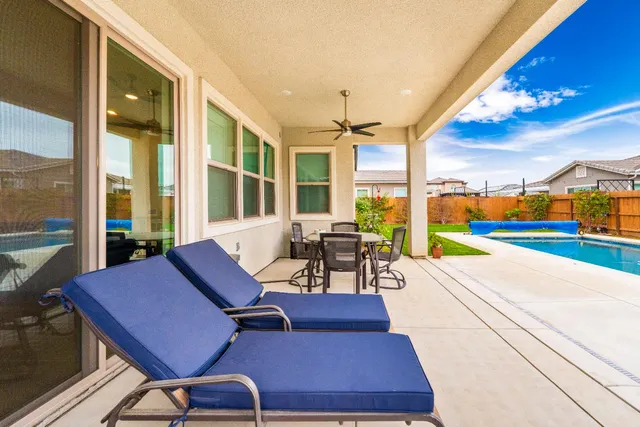 a view of a swimming pool with an outdoor seating