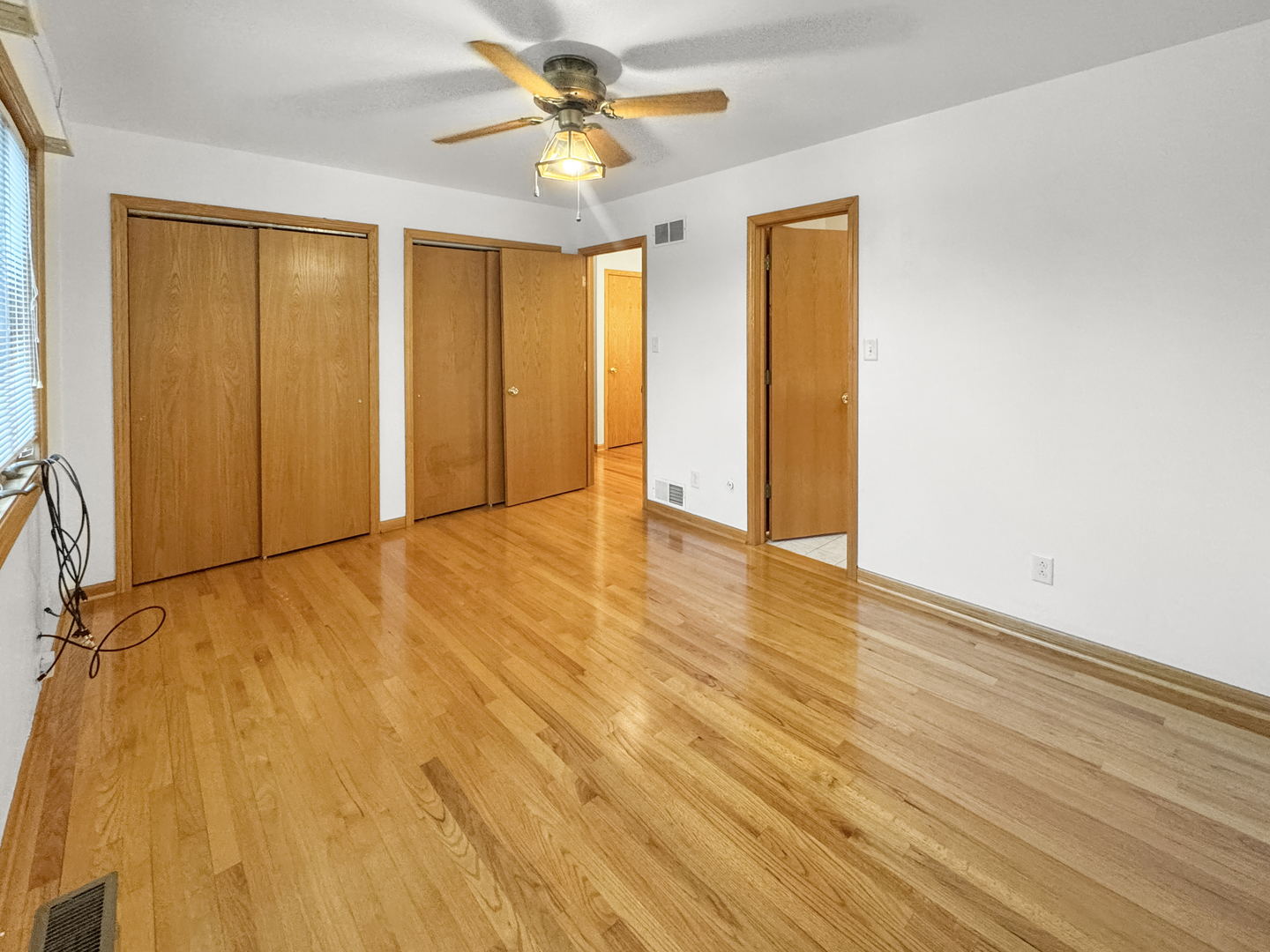 1105 Summit Drive Lockport, IL 60441 - Photo 11 of 15 a view of an empty room with window and wooden floor