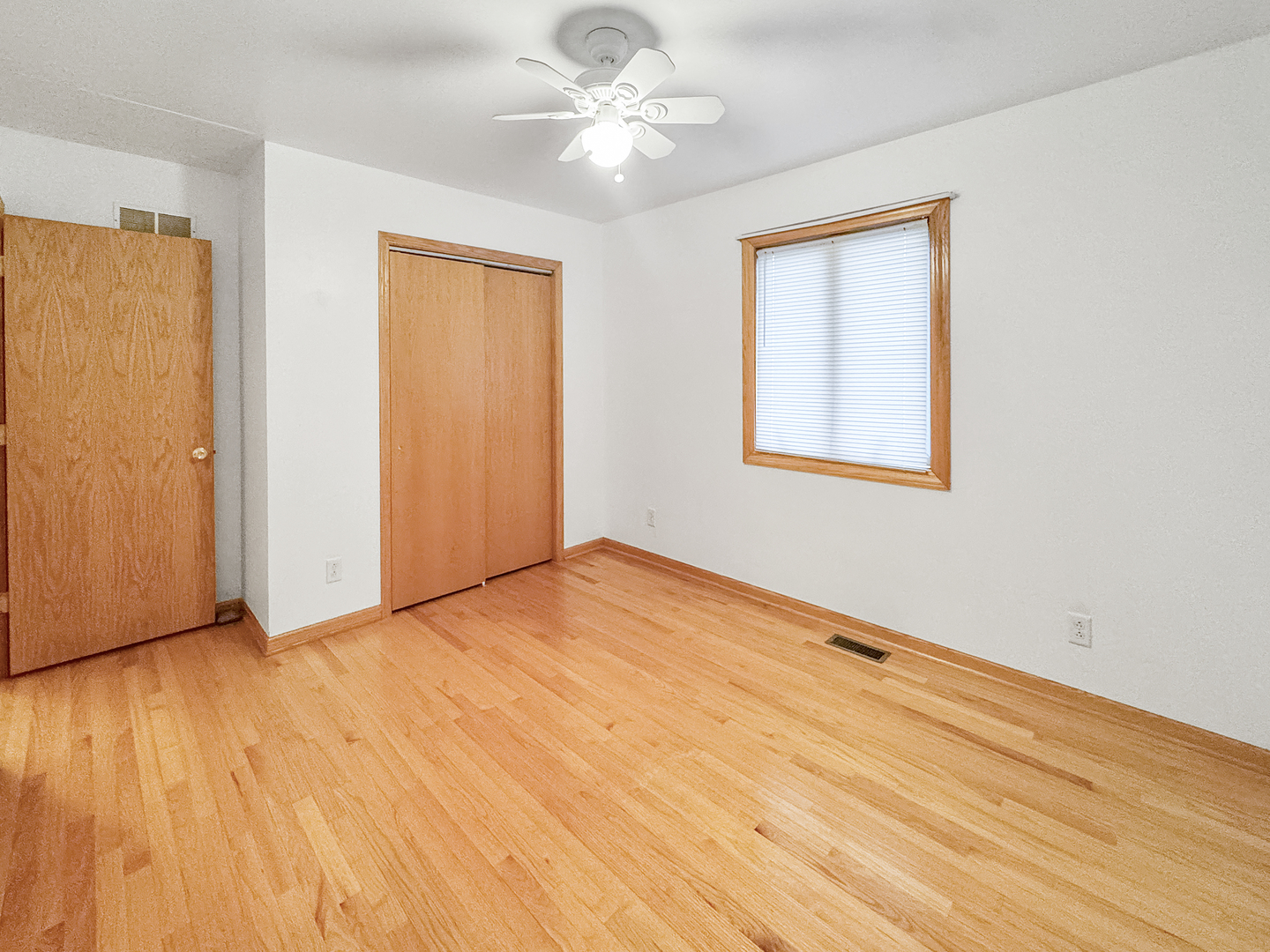1105 Summit Drive Lockport, IL 60441 - Photo 13 of 15 a view of an empty room with window and wooden floor