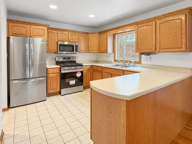 a kitchen with a sink cabinets and wooden floor