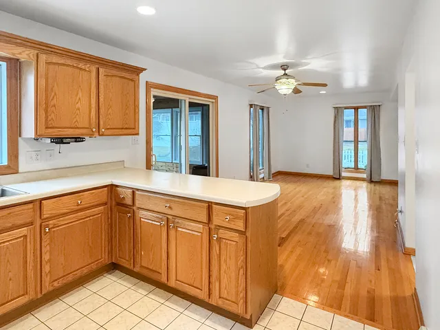 a view of a kitchen with furniture and wooden floor