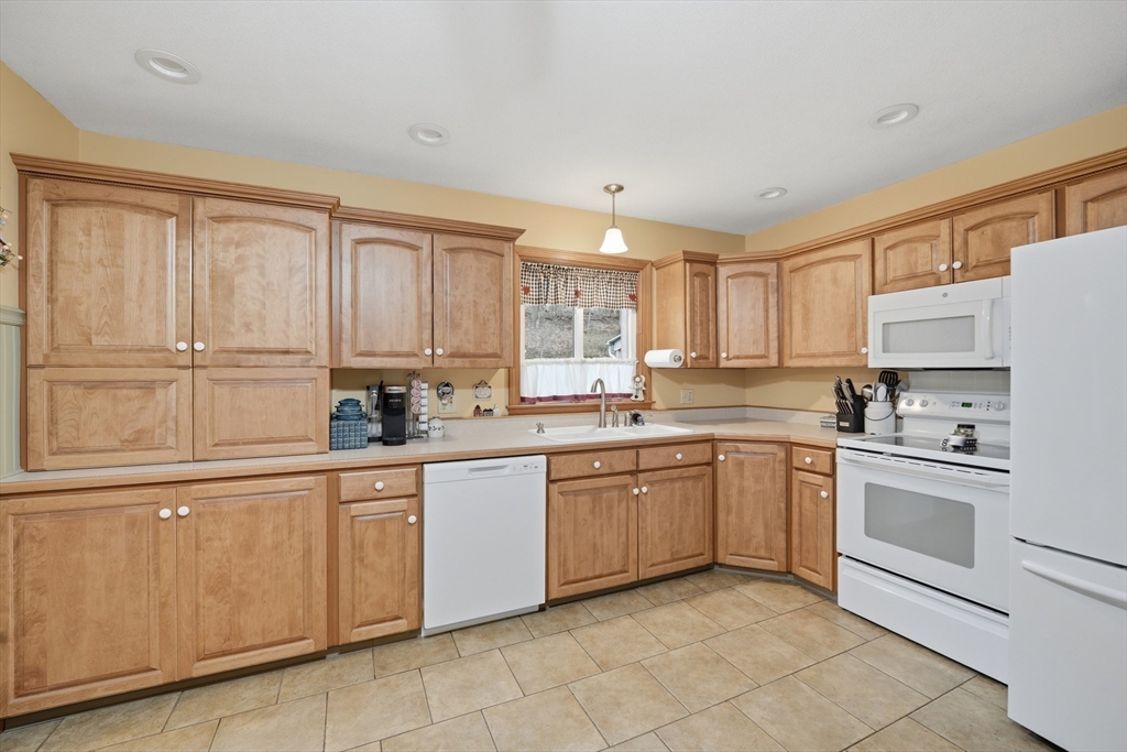 5 Westview Terrace Easthampton, MA 01027 - Photo 11 of 39 a kitchen with white cabinets white appliances and sink