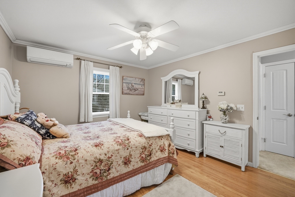 5 Westview Terrace Easthampton, MA 01027 - Photo 24 of 39 a bedroom with a large bed and a chandelier fan