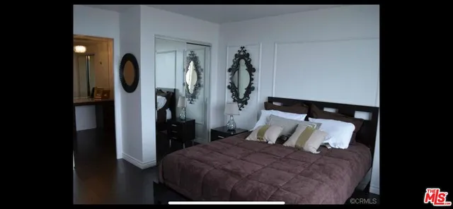 a bedroom with a bed and a mirror