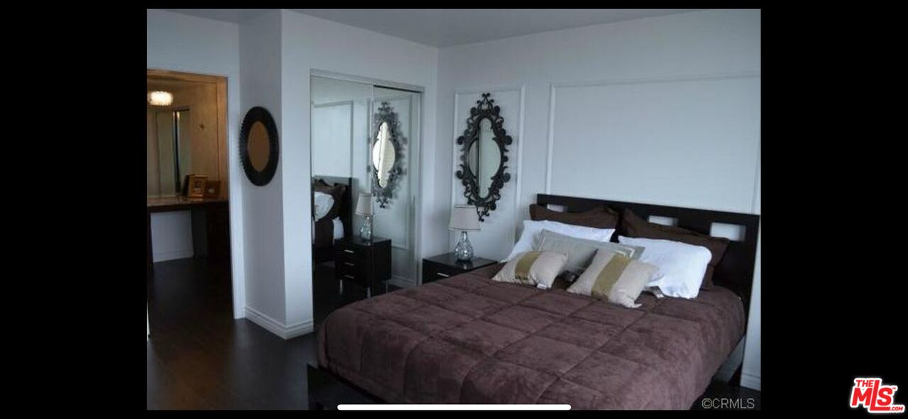 2170 Century Park East, Unit 1611 Los Angeles, CA 90067 - Photo 14 of 41 a bedroom with a bed and a mirror